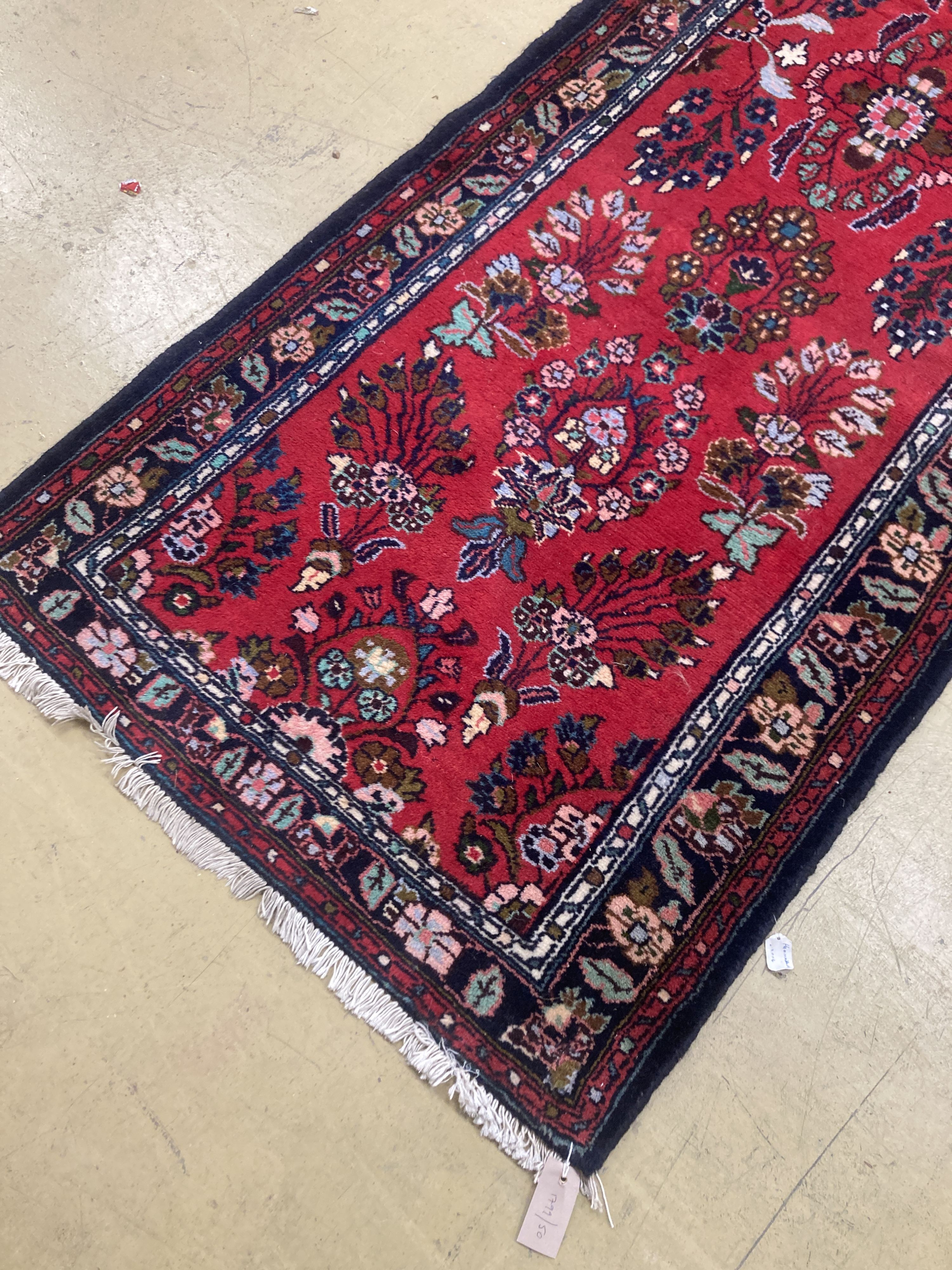 A Hamadan red ground runner with floral design, 280 x 84cm